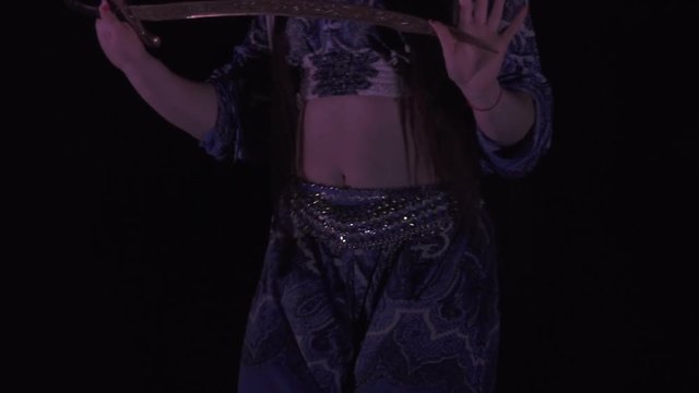Sexy, young woman belly dancer arabian in exotic dress dancing exotic dance.