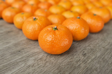 Small oranges on wooden table