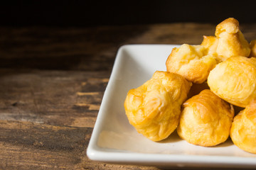 Choux Dough plate on a white background old wood