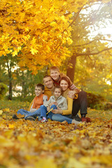 family in autumn forest