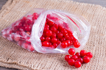 Frozen berries of a viburnum in a bag on a table