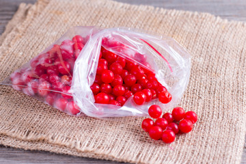 Frozen berries of a viburnum in a package on a table