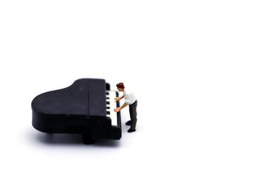 Miniature people : man play mini piano