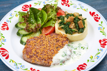 meat with mashed potato and salad