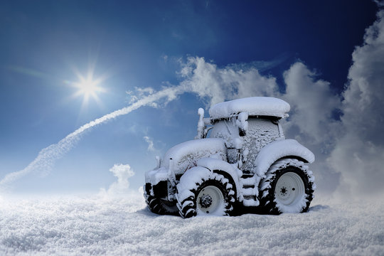 Eingeschneiter Traktor steht im tiefen Schnee