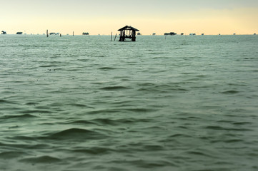 Landscape of fisherman hut for rest with beautiful sunset in the sea