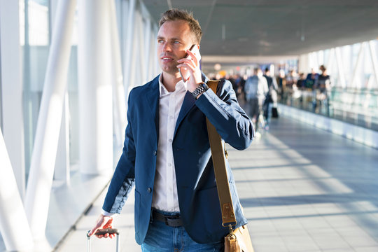 Man talking on phone in airport