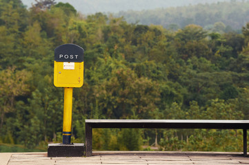 Post box with chair on tree background