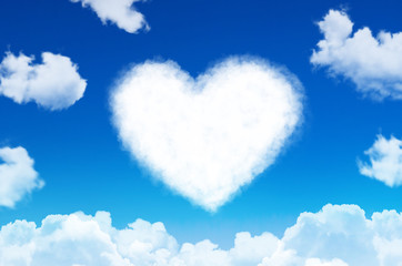 Naklejka na ściany i meble Heart of clouds symbol of love on blue sky.