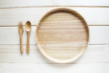 Wooden kitchen utensils on wooden background