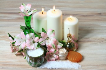 Spa concept, candles, flower, body cream, bath crystals, soap, perfume 