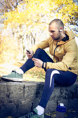 Rest from exercise. Young man in nature.