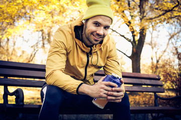 Fototapeta premium Young man resting after exercise listening music.