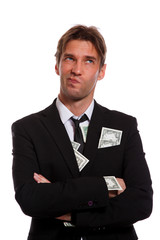Photo of pensive man in business suit with dollars in pockets