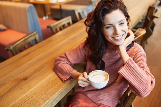 woman drinking coffee in a cafe