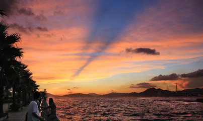 the cloudscape of victoria harbour view in sunset in hong kong, Cumulonimbus clouds with Anti-crepuscular rays