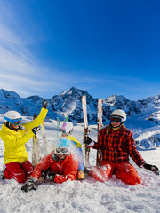 Happy family enjoying winter vacations in mountains. Playing with snow, Sun in high mountains. Winter holidays.