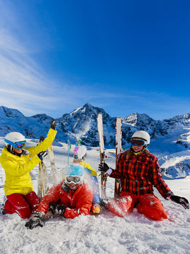 Happy family enjoying winter vacations in mountains. Playing with snow, Sun in high mountains. Winter holidays.