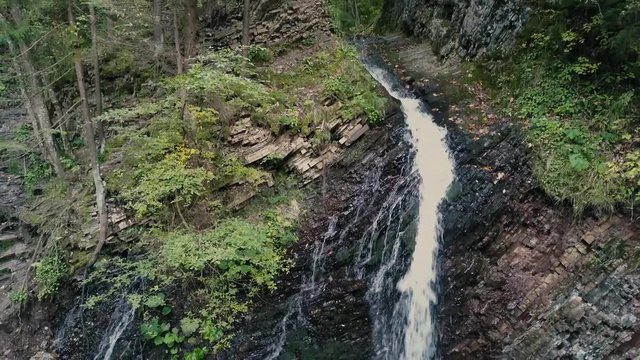 Beautiful autumn waterfall Zhenetskyi Huk in carpathian mountains, Ukraine. Aerial shoot from drone