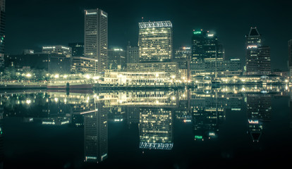 Baltimore  skyline and docks reflecting in the water at night