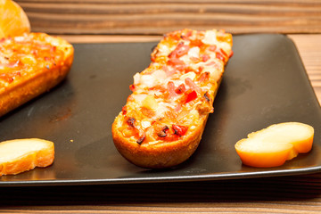 Italian bruschetta with roasted tomatoes, mozzarella cheese and herbs