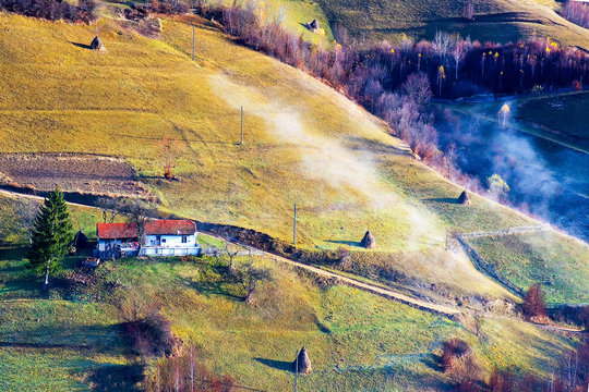 Stunning autumn nature with misty landscape,Holbav village,Carpathians,Transylvania,Romania,Europe