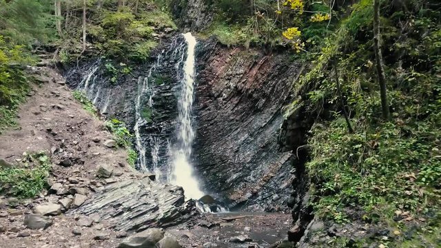 Beautiful autumn waterfall Zhenetskyi Huk in carpathian mountains, Ukraine. Aerial shoot from drone