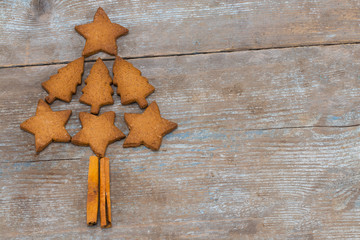 christmas tree made from gingerbread cookies on wooden background with copy space for text. holiday, celebration and cooking concept. new year and christmas postcard