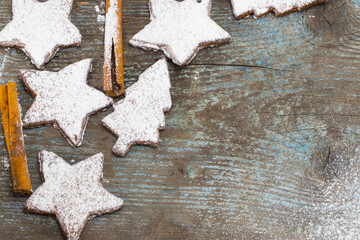 Christmas wooden background with gingerbread cookies. Top view with copy space for your greetings