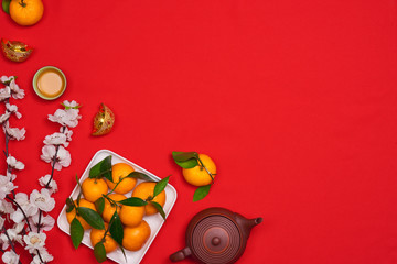 celebrate Chinese New Year background with orange fruit for warship, red envelope and beautiful...
