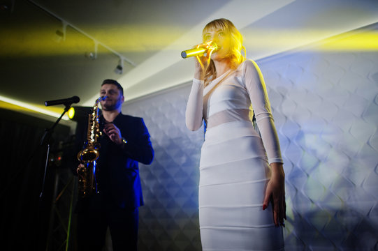 Musicial music live band performing on a stage with different lights.
