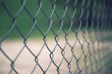 Abstract blurry outside  wire fence background. Selective focus used.