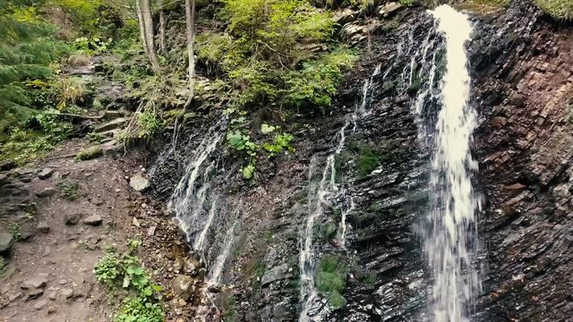 Beautiful autumn waterfall Zhenetskyi Huk in carpathian mountains, Ukraine. Aerial shoot from drone