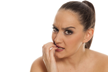 Naklejka premium beautiful young frustrated woman posing on white background