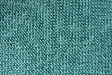 Handmade turquoise knitted fabric directly from above