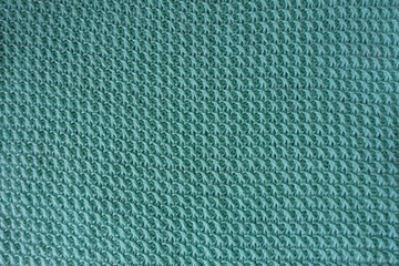 Handmade turquoise knitted fabric directly from above