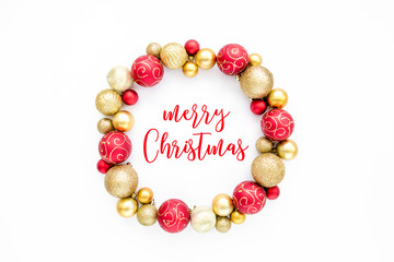 Holiday round frame, pattern made of red and gold glass Christmas balls isolated on a white background. Merry Christmas. The apartment lay, top view