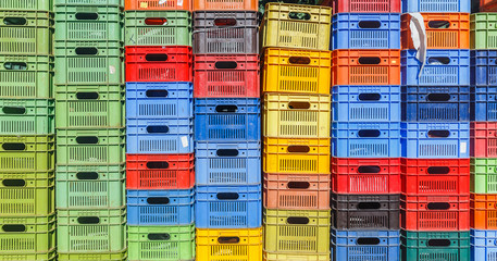 Colored plastic boxes for fruit stacked in piles