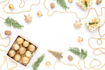 Christmas or new year texture. Christmas decorations in gold colors on white background. Holiday and celebration concept. Top view. Flat lay