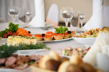 Holiday luxury table with gourmet food. New year's eve feast with delicious dishes. The anniversary of the restaurant. 