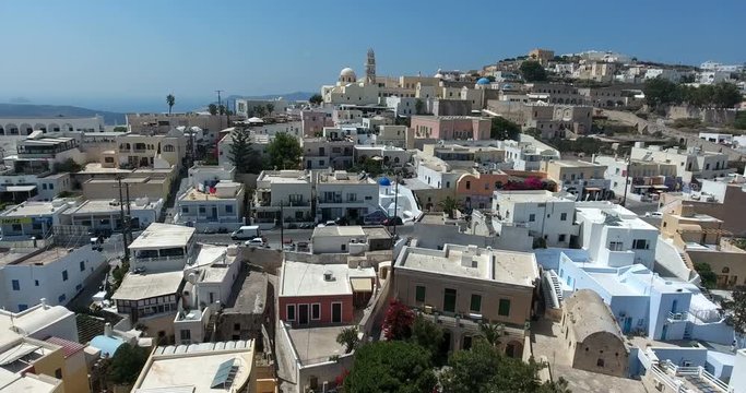 SANTORINI, GREECE – AUGUST 2016 : Aerial shot over Santorini cityscape on a sunny day with beautiful landscape and colors in view