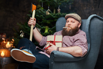 Fototapeta premium Plump bearded hipster male in a room.