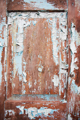 Very old wooden door with cracked blue paint.