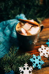 hot chocolate with marshmallows in a ceramic cup on bright wooden surface