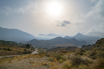 misty greek landscape with mountains and road