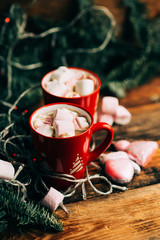 Obraz na płótnie Canvas Christmas Hot Chocolate with Marshmallows in Red Mugs, square