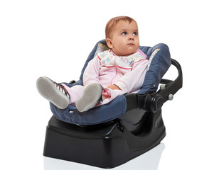 Smiling infant baby child sitting in a car seat, isolated on white