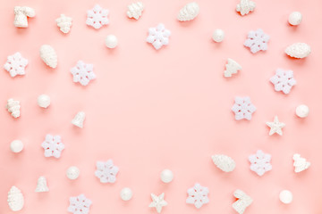 Beautiful Christmas frame, background with white snowflakes on pink background with empty copy space for text. Holiday and celebration concept. Flat lay, top view