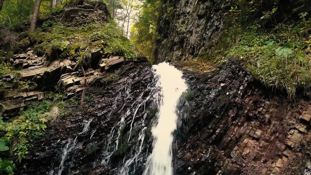 Beautiful autumn waterfall Zhenetskyi Huk in carpathian mountains, Ukraine. Aerial shoot from drone