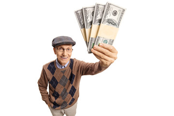 Elderly man showing bundles of money